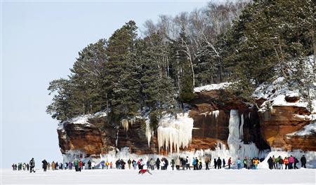 Sightseers trek across a frozen expanse of Lake Superior, the world's largest freshwater lake, to the sea caves of the Apostle Islands National Lakeshore near Cornucopia, Wisconsin February 14, 2014. REUTERS/Eric Miller