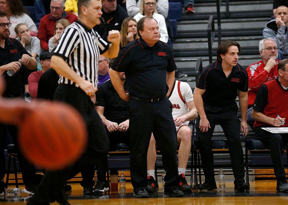 Crestview High School's head coach John Kurtz and his son assistant coach Kyle Kurtz, right, on the bench against Huron High School during their Division III district semifinal high school boys basketball game at Norwalk High School Wednesday, March 1, 2023. TOM E. PUSKAR/ASHLAND TIMES-GAZETTE