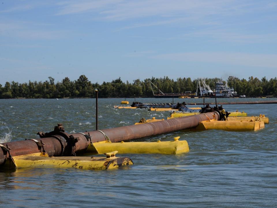 floating pipes infrastructure laid out across surface of river