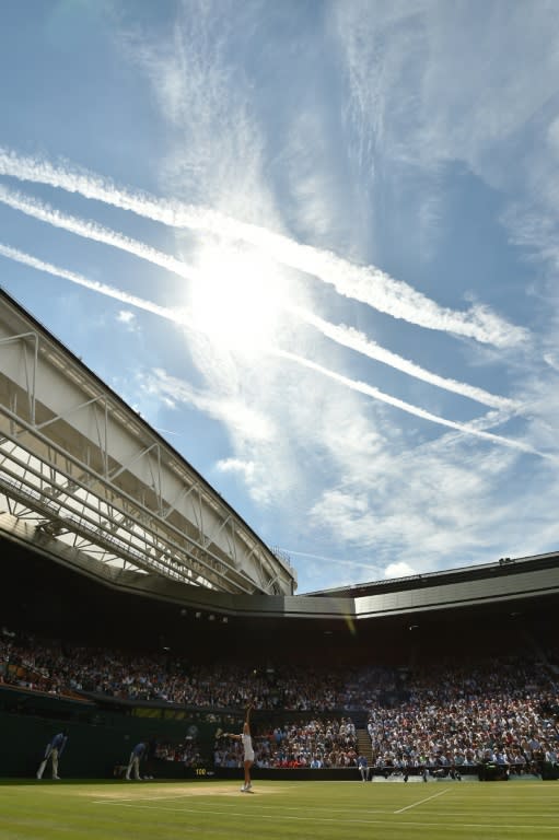 Russia's Elena Vesnina serves to Serena Williams of the US during their Wimbledon Championships women's semi-final match, at The All England Lawn Tennis Club in south-west London, on July 7, 2016