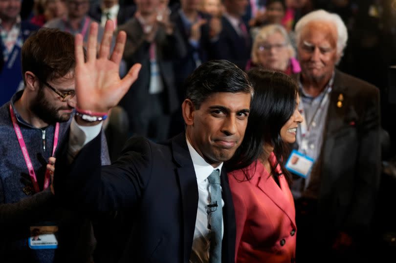 Prime Minister Rishi Sunak waves as he and his wife Akshata Murty leave following his speech during the final day of the Conservative Party Conference