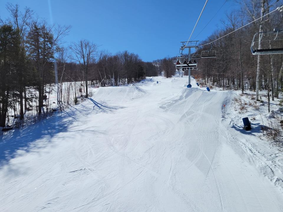 Windham mountain ski resort during the winter and early spring skiing with sunny skies with chairlift in view