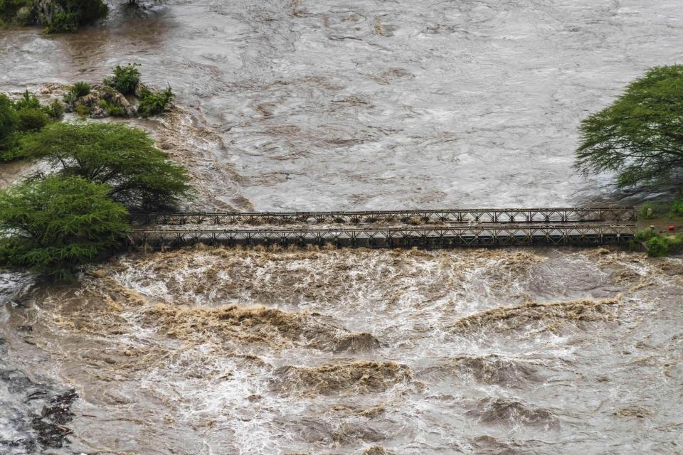 Flood waters cover a bridge in the flooded Maasai Mara National Reserve, that left dozens of tourists stranded in Narok County, Kenya, Wednesday, May 1, 2024. Kenya, along with other parts of East Africa, has been overwhelmed by flooding. (AP Photo/Bobby Neptune)