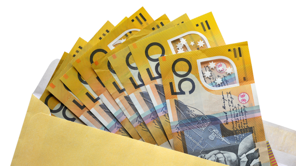 Yellow envelope with Australian $50 notes. 