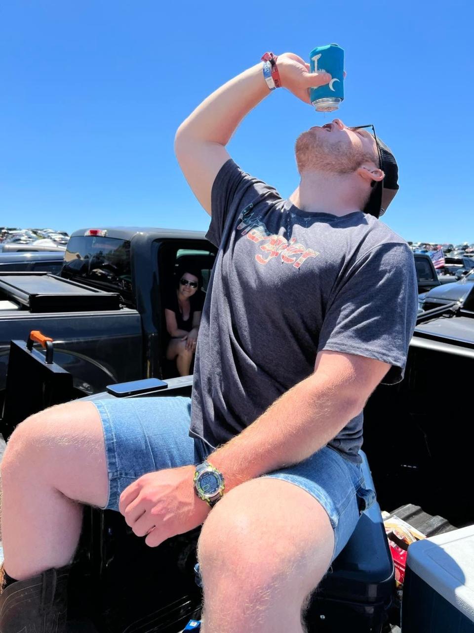 Brandon Vocco finishes a beer in the back of a pickup truck during a tailgating party at Country Fest at Clay's Resort Jellystone Park in Stark County.