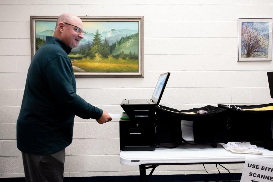 Joe McCreavy, of Doylestown Township, inserts his ballot into a scanner at the Central Bucks Senior Center, in Doylestown Township, during the general elections on Tuesday, Novemeber 7, 2023.