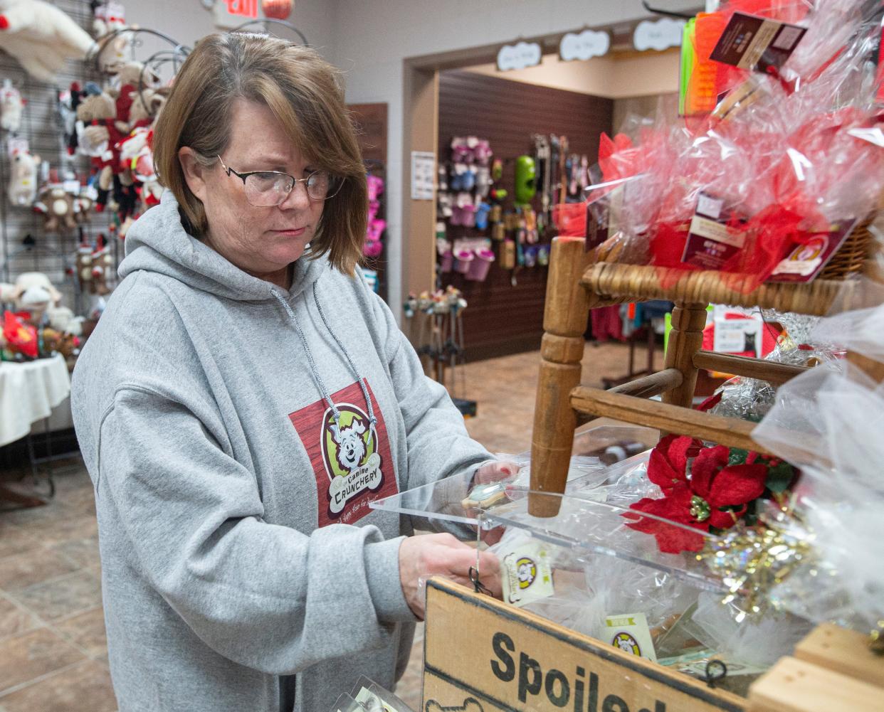 Jane Femminella, owner of The Canine Crunchery, Inc. checks the cookie display on Friday, Dec. 9, 2022, at The Canine Crunchery, Inc. in Rockford.