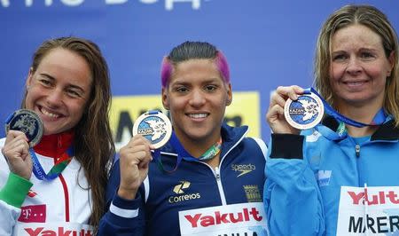 Brazil's Ana Marcela Cunha is flanked by Hungary's silver medalist Anna Olasz (L) and Germany's bronze medalist Angela Maurer as they pose with their medals during the podium ceremony for the women's 25km open water race at the Aquatics World Championships in Kazan, Russia August 1, 2015. REUTERS/Hannibal Hanschke