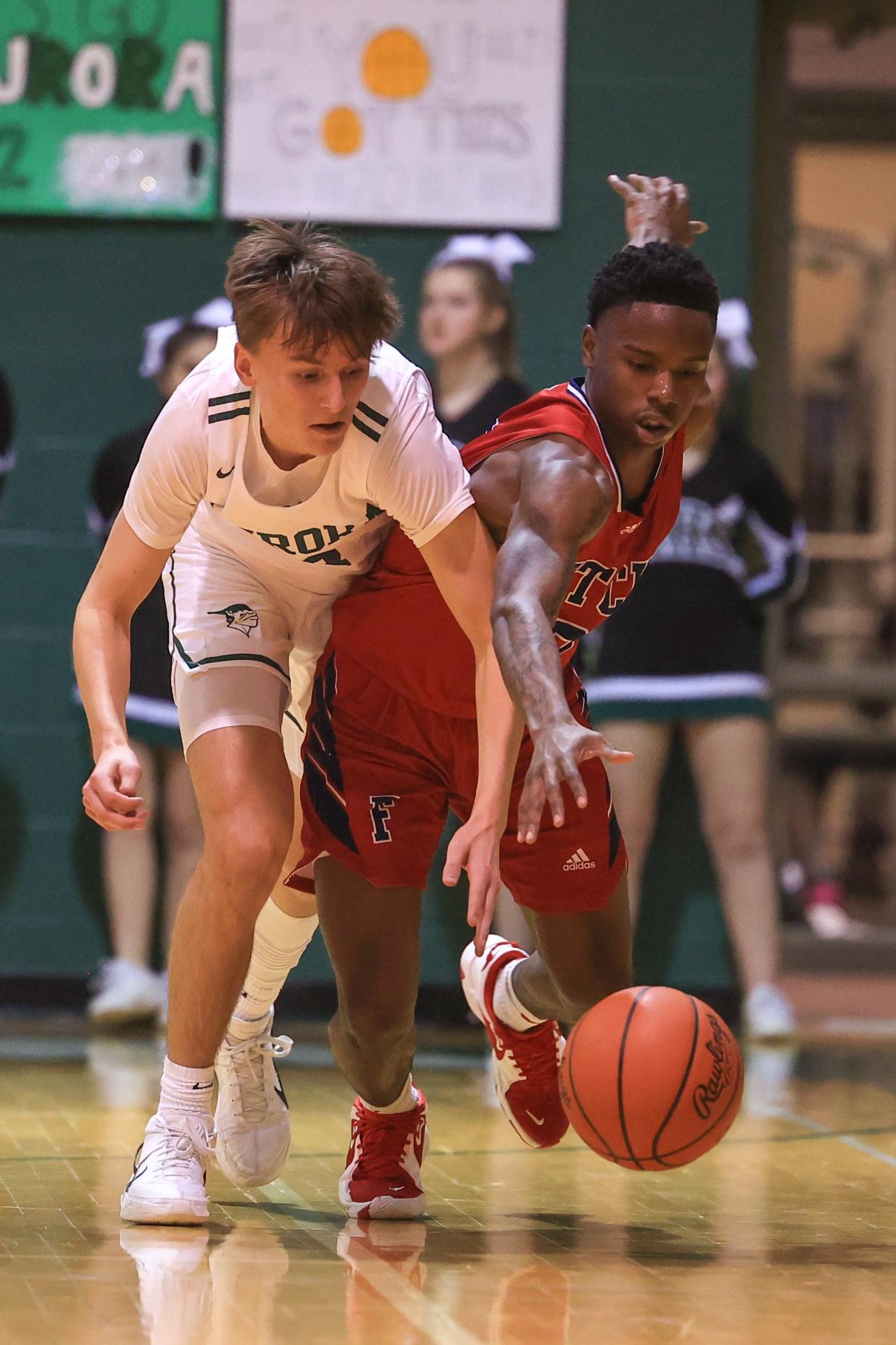 Aurora senior John Ugran and Austintown-Fitch senior Allen Underwood battle for a loose ball during Saturday night's playoff game at Aurora High School.