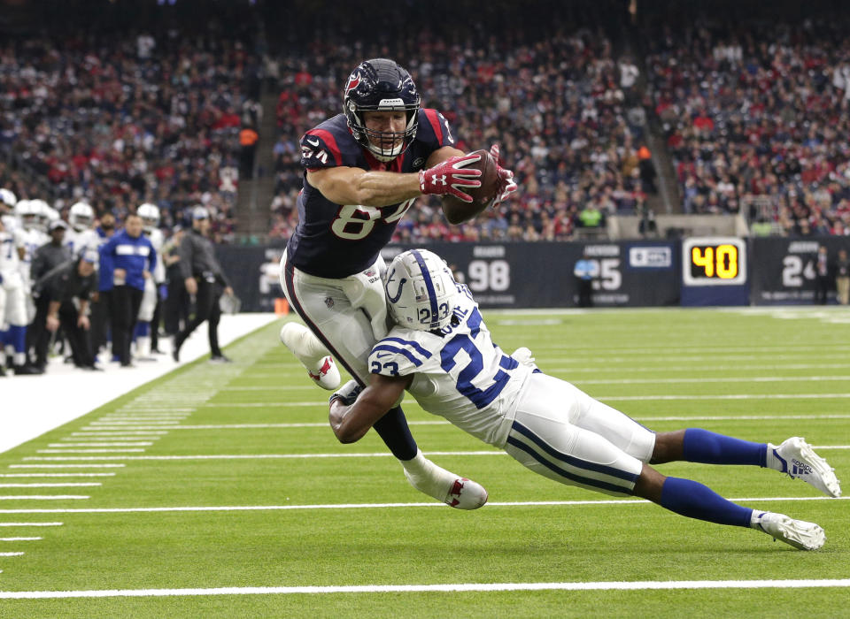 Houston Texans tight end Ryan Griffin (84) reaches for the goal line after catching a pass as Indianapolis Colts cornerback Kenny Moore (23) defends during the second half of an NFL football game Sunday, Dec. 9, 2018, in Houston. Griffin was ruled down just short of the end zone. (AP Photo/Michael Wyke)