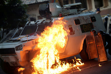 A riot security force vehicle is set on fire at a rally during a strike called to protest against Venezuelan President Nicolas Maduro's government in Caracas. REUTERS/Ueslei Marcelino