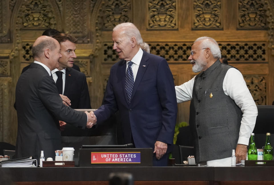 U.S. President Joe Biden, France's President Emmanuel Macro, Germany's Chancellor Olaf Scholz and India's Prime Minister Narendra Modi greet each other during the first working session of the G20 leaders summit in Nusa Dua, Indonesia, Tuesday, Nov. 15, 2022. (Kevin Lamarque/Pool via AP)