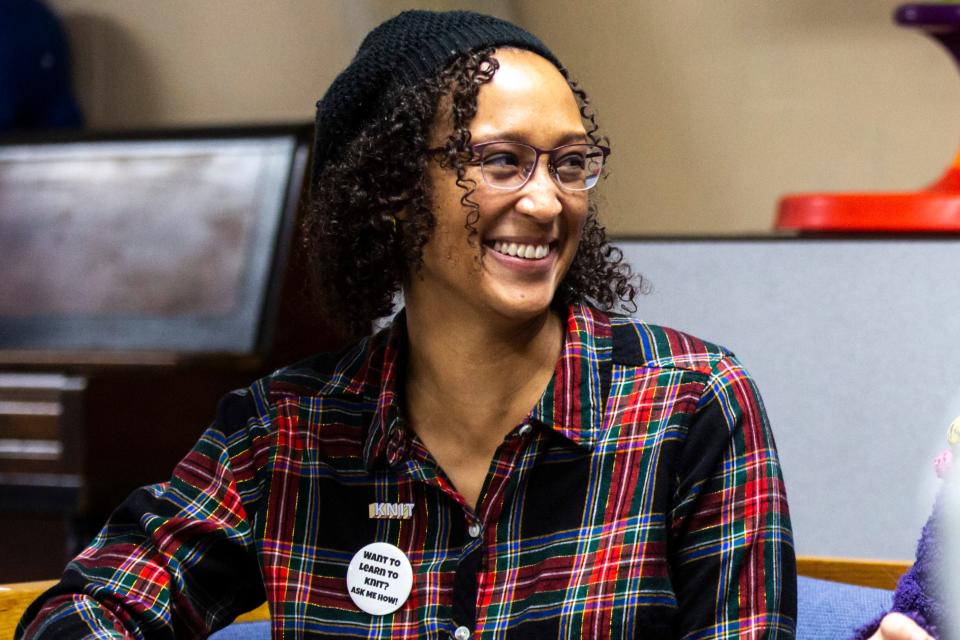 Angie Jordan, member of the South District Neighborhood Association, smiles during a "Banjo Knits Projects" weekly knitting circle, Saturday, Dec. 14, 2019, at the Broadway Neighborhood Center in Iowa City, Iowa.