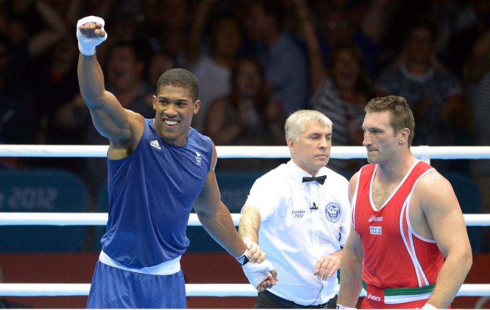 Anthony Joshua (left) celebrates after winning the super heavyweight gold medal in the 2012 Olympics. Damien Meyer / AFP/Getty Images