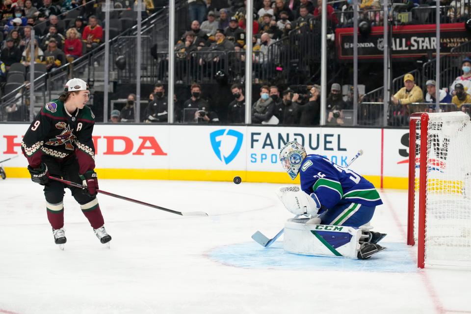 Vancouver Canucks goalie Thatcher Demko, right, and Phoenix Coyotes' Clayton Keller participate in the Skills Competition save streak event, part of the NHL All-Star weekend, Friday, Feb. 4, 2022, in Las Vegas. (AP Photo/Rick Scuteri)