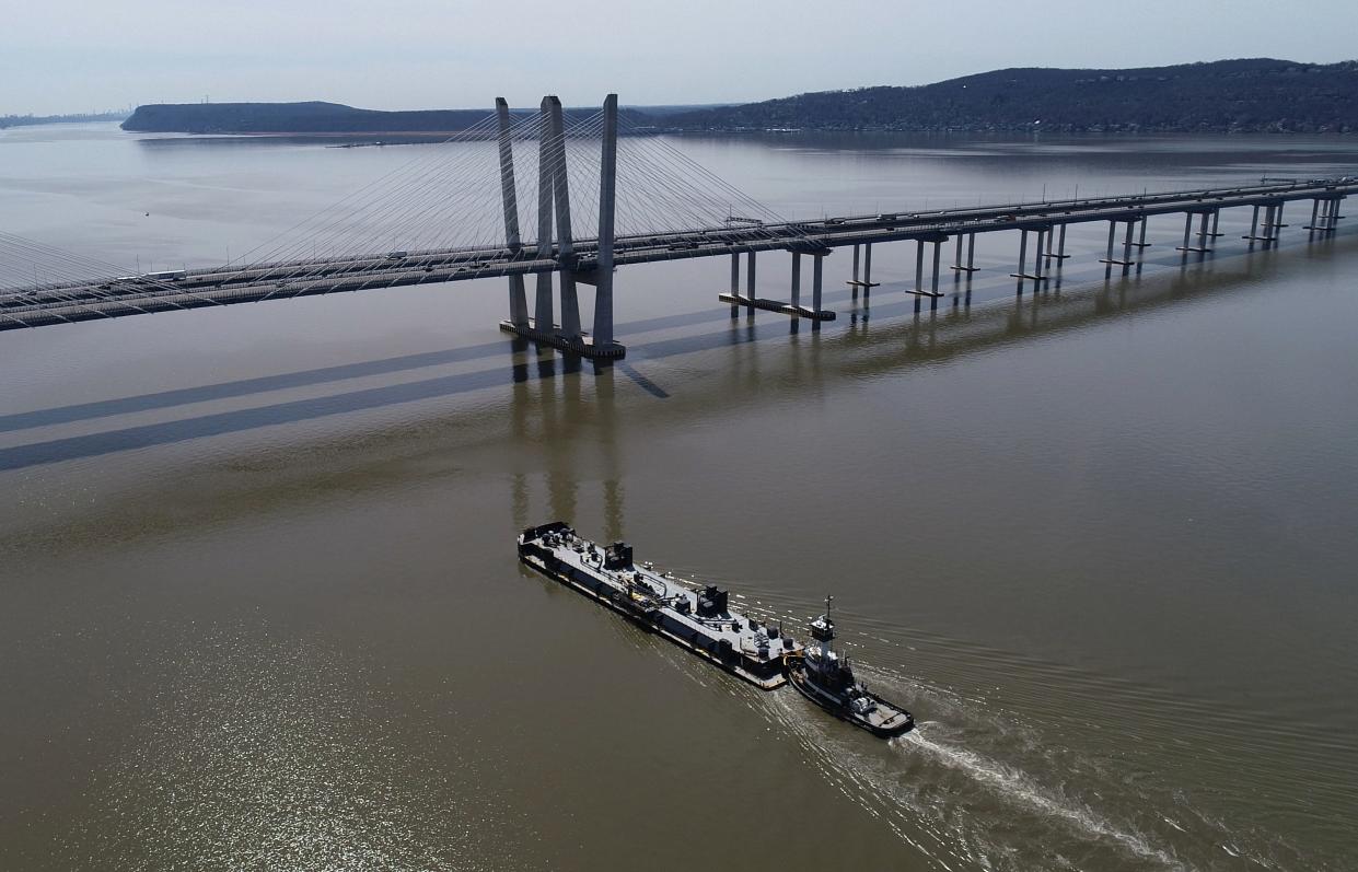 The tugboat Treasure Coast pushes a barge down the Hudson River near the Gov. Mario Cuomo Bridge April 9, 2024.