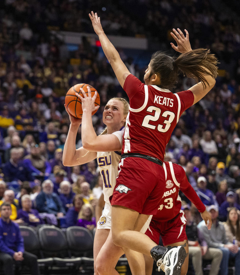 LSU guard Hailey Van Lith (11) makes a move to the hoop against Arkansas guard Carly Keats (23) in the first period of an NCAA college basketball game Sunday, Jan. 21, 2024, in Baton Rouge, La. (Michael Johnson/The Advocate via AP)