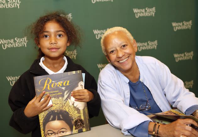 Nikki Giovanni poses with a smiling young fan at a 2010 book signing of 