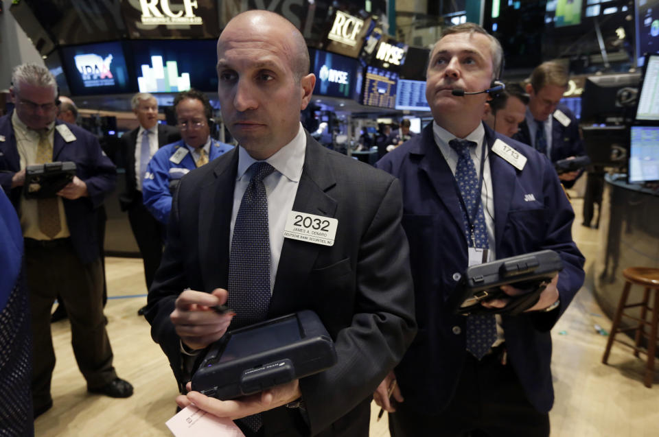 Trader James Denaro, center, works on the floor of the New York Stock Exchange, Monday, April 7, 2014. Stocks are starting out the week the same way they ended the last one, down. (AP Photo/Richard Drew)