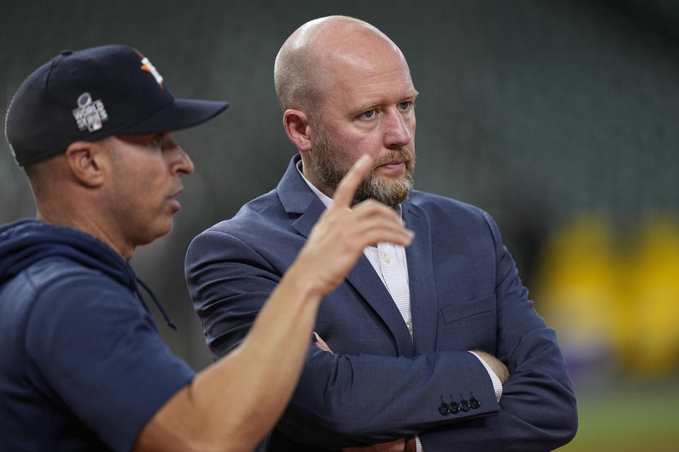 Houston Astros general manager James Click, right, talks with bench coach Joe Espada during batting practice before Game 1 in baseball's World Series against the Atlanta Braves Tuesday, Oct. 26, 2021, in Houston. (AP Photo/David J. Phillip)