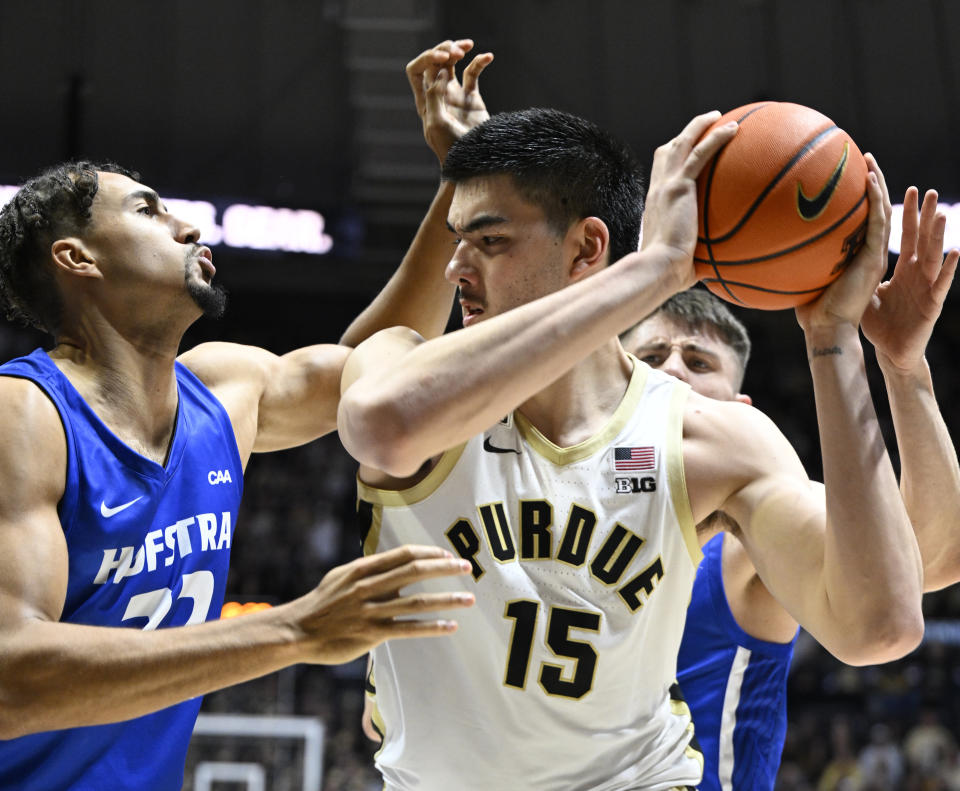 Dec 7, 2022; West Lafayette, Indiana, USA; Purdue Boilermakers center Zach Edey (15) keeps the ball away from Hofstra Pride forward Nelson Boachie-Yiadom (32) during the second half at Mackey Arena. Boilermakers defeated the Pride 85-66. Mandatory Credit: Marc Lebryk-USA TODAY Sports