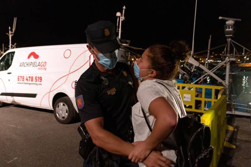 Sarah Bettache is stopped by a Spanish National Police officer as she tries to find her brother Ahmed, a migrant from Morocco, in the port of Arguineguin