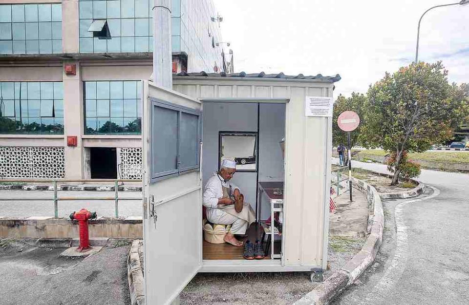 Cobbler Osman Sidek says he needs only 30 minutes to repair a pair of shoes and he charges between RM10 and RM20 for repair work. — Farhan Najib