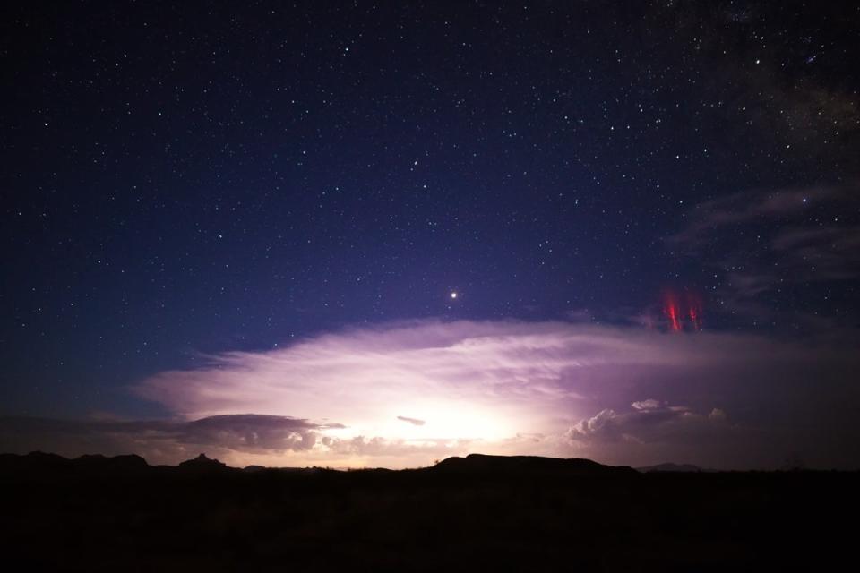 Sprite lightning, the reddish streaks on the right, as seen over a thunderstorm in Arizona. The phenomenon was also seen this week around the outer edges of Tropical Storm Nicole (Getty Images/iStockphoto)