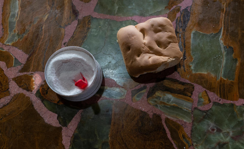 A meal consisting of bread and sugar is laid out on the table at Cristian Molina's family home in the shantytown of Lujan, Buenos Aires, Argentina, Aug. 17, 2019. Molina contracted tuberculosis earlier this year. He shares living spaces with his parents, six siblings and four nephews. Doctors think one brother contracted the disease in prison before spreading it around the family when he returned home. (Photo: Magali Druscovich/Reuters)