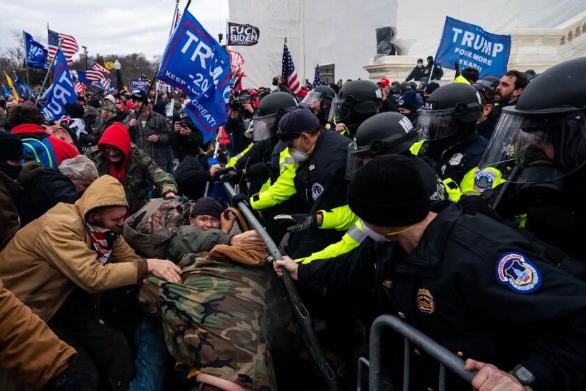 WASHINGTON, DC - JANUARY 06: Pro-Trump supporters clash with law enforcement on the west steps/inauguration stage of the U,S. Capitol as people gathered on the second day of pro-Trump events fueled by President Donald Trump's continued claims of election fraud in an to overturn the results before Congress finalizes them in a joint session of the 117th Congress on Wednesday, Jan. 6, 2021 in Washington, DC. (Kent Nishimura / Los Angeles Times)