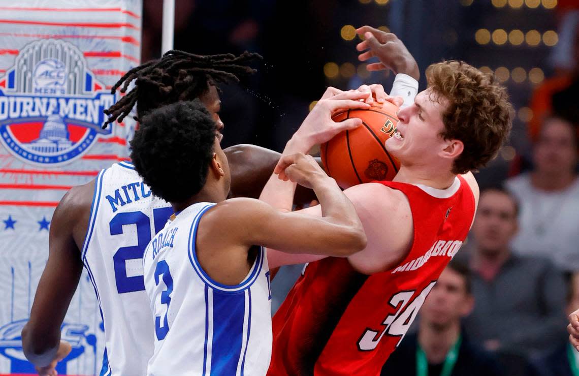 N.C. State’s Ben Middlebrooks (34) pulls in the rebound from Duke’s Jeremy Roach (3) and Mark Mitchell (25) during the second half of N.C. State’s 74-69 victory over Duke in the quarterfinal round of the 2024 ACC Men’s Basketball Tournament at Capital One Arena in Washington, D.C., Thursday, March 14, 2024.