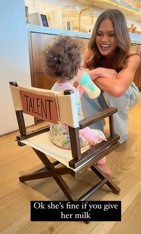 <p>Chrissy Teigen/Instagram</p> Chrissy Teigen smiles at daughter Esti during her photo shoot