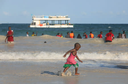 Young boy walks along the seashore on the Lido beach in Mogadishu, Somalia May 1, 2019. Picture taken May 1, 2019. REUTERS/Feisal Omar