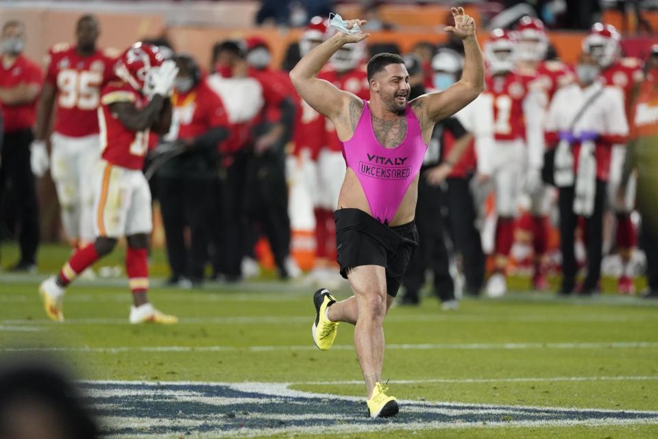 A fan runs on the field during the second half of Super Bowl LV at Raymond James Stadium in Tampa, Fla.