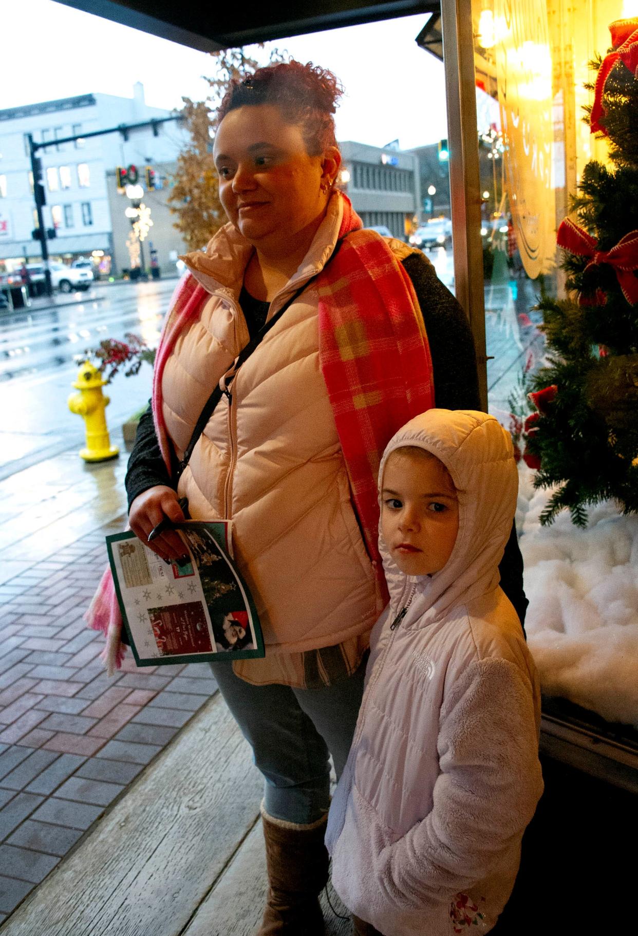 Aubrey Freyman and daughter Gracelyn are busy looking for Elf on the Shelf in the scavenger hunt in downtown stores.