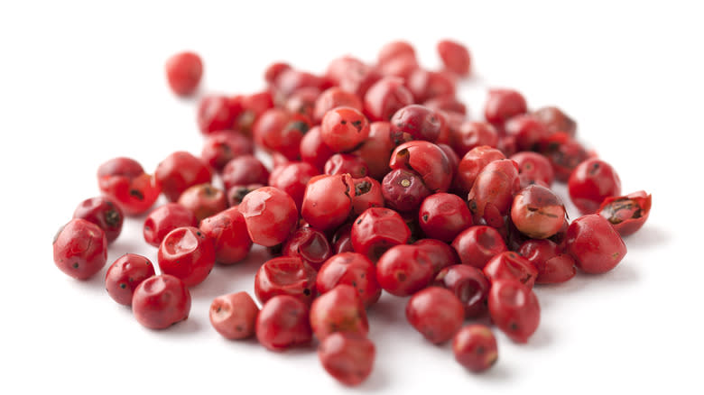 pink peppercorns white background 