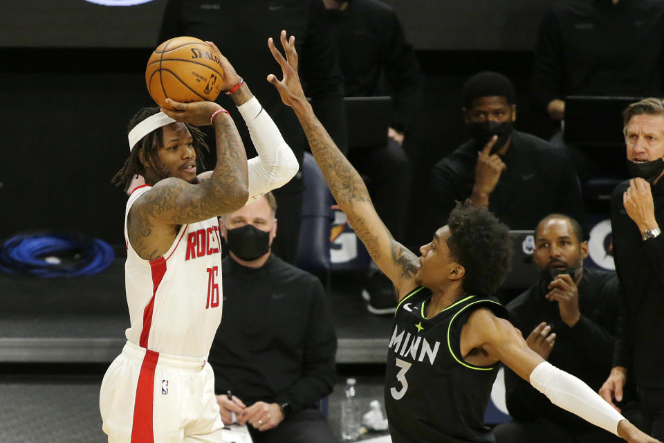 Houston Rockets guard Ben McLemore (16) shoots against Minnesota Timberwolves forward Jaden McDaniels (3) in the fourth quarter during an NBA basketball game, Friday, March 26, 2021, in Minneapolis. (AP Photo/Andy Clayton-King)
