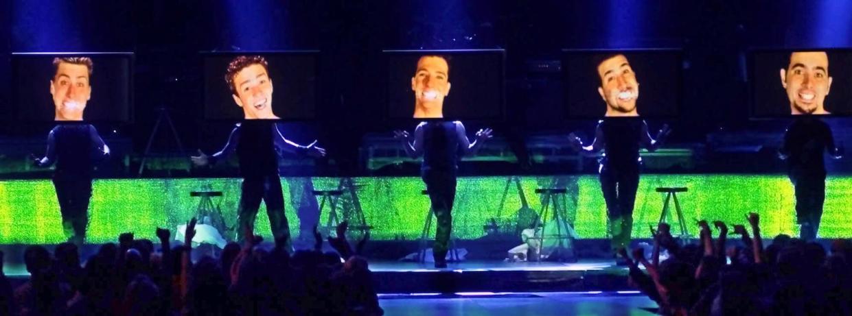 NSync performs at the 2000 MTV Video Music Awards at Radio City Music Hall in New York. The group's faces are projected onto video screens as the singers stand behind the screens.