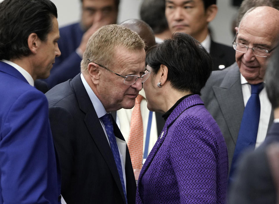 In this Friday, Nov. 1, 2019, file photo, IOC member John Coates, center left, talks with Tokyo Governor Yuriko Koike as they leave the Four-Party Representative Meeting in Tokyo. Next year's Olympic marathons and race walks will be run in the northern city of Sapporo as the IOC has followed through with a controversial plan to move from Tokyo to the cooler northern city. (Kimimasa Mayama /Pool Photo via AP, File)