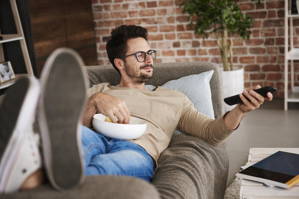 a man watching TV on his couch