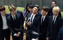 FILE- In this Sept. 24, 2018, file photo, members of the Korean K-Pop group BTS attend a meeting at the United Nations high level event regarding youth during the 73rd session of the United Nations General Assembly at U.N. headquarters. The agency for the South Korean band BTS on Wednesday, Nov. 14, 2018, has apologized for a member wearing a T-shirt depicting the explosion of an atomic bomb.(AP Photo/Craig Ruttle, File)