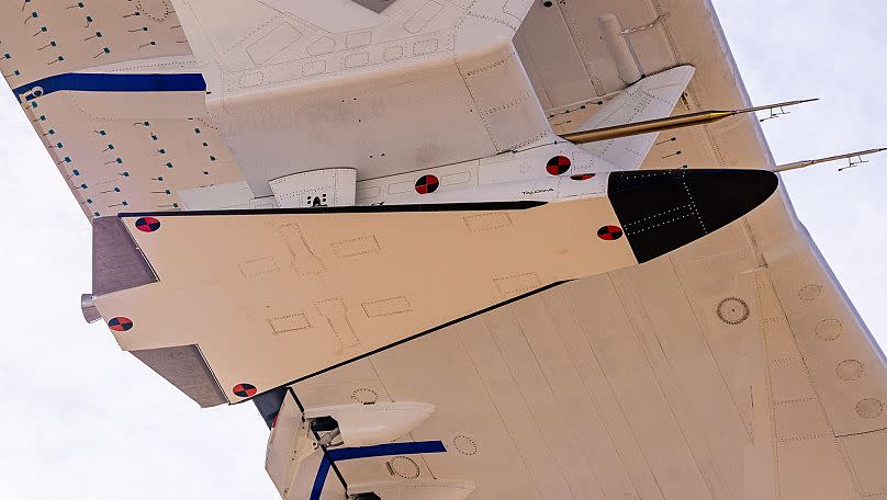 The unmanned Talon-A-1 test vehicle attached beneath the wings of the six-engined Roc aircraft.