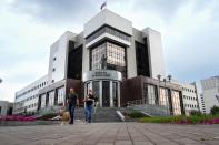 People walk past the court building with the words reading, "Palace of justice," on the front in Yekaterinburg, Russia, Thursday, July 18, 2024, prior to a hearing of Wall Street Journal reporter Evan Gershkovich's suspected spying activities. Gershkovich has attended a hearing behind closed doors in his trial in Russia on espionage charges that he, his employer and the U.S. government vehemently deny. Closing arguments are set for Friday. Authorities arrested the 32-year-old journalist on March 29, 2023, while he was on a reporting trip and claimed without offering any evidence that he was gathering secret information for the U.S. (AP Photo/Dmitri Lovetsky)