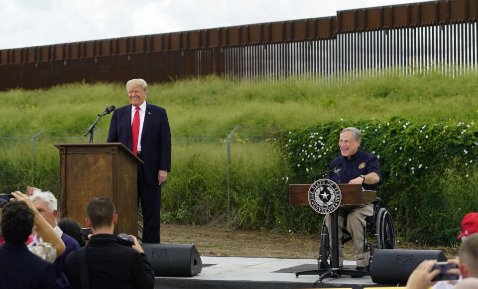 Former President Donald Trump, left, and Texas Gov. Greg Abbott, right, visit an unfinished section of border wall, in Pharr, Texas, Wednesday, June 30, 2021. (AP Photo/Eric Gay)