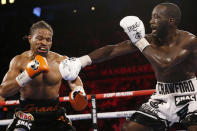 Terence Crawford hits Shawn Porter during a welterweight title boxing match Saturday, Nov. 20, 2021, in Las Vegas. (AP Photo/Chase Stevens)