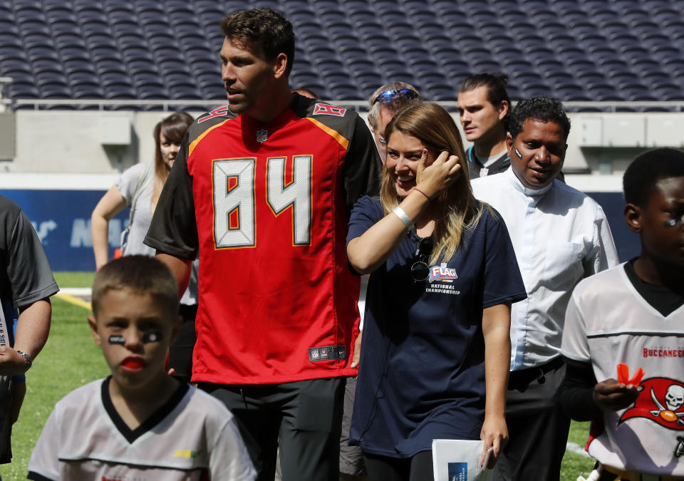 NFL player Cameron Brate of Tampa Bay Buccaneers leaves the pitch after coaches a young team during the final tournament for the UK's NFL Flag Championship, featuring qualifying teams from around the country, at the Tottenham Hotspur Stadium in London, Wednesday, July 3, 2019. The new stadium will host its first two NFL London Games later this year when the Chicago Bears face the Oakland Raiders and the Carolina Panthers take on the Tampa Bay Buccaneers. (AP Photo/Frank Augstein)