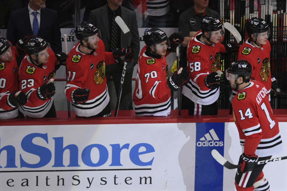 Chicago Blackhawks' Boris Katchouk (14) celebrates with teammates at the bench after scoring during the second period of an NHL hockey game against the Dallas Stars, Saturday, Jan 13, 2024, in Chicago. (AP Photo/Paul Beaty)