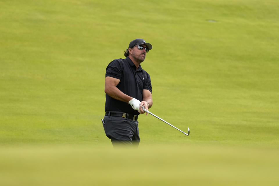 Phil Mickelson watches his shot on the eighth hole during the first round of the U.S. Open golf tournament at The Country Club, Thursday, June 16, 2022, in Brookline, Mass. (AP Photo/Charlie Riedel)