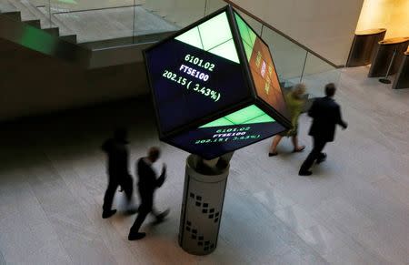 People walk through the lobby of the London Stock Exchange in London, Britain August 25, 2015. REUTERS/Suzanne Plunkett