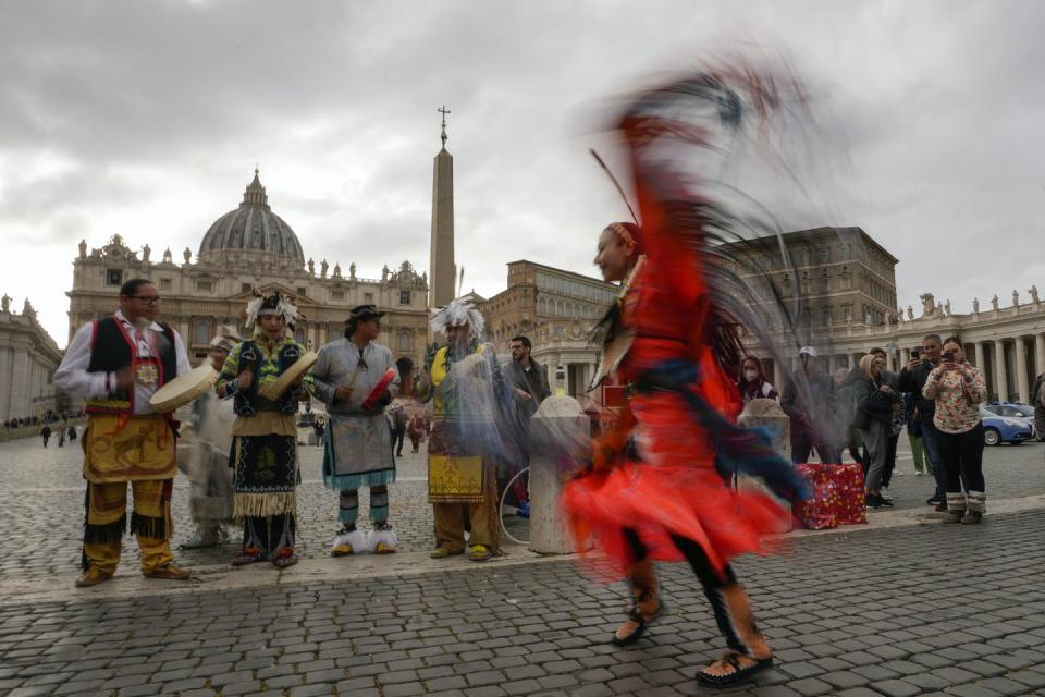 Members of an Indigenous delegation perform in St. Peter’s Square in March 2022. (AP Photo/Alessandra Tarantino)